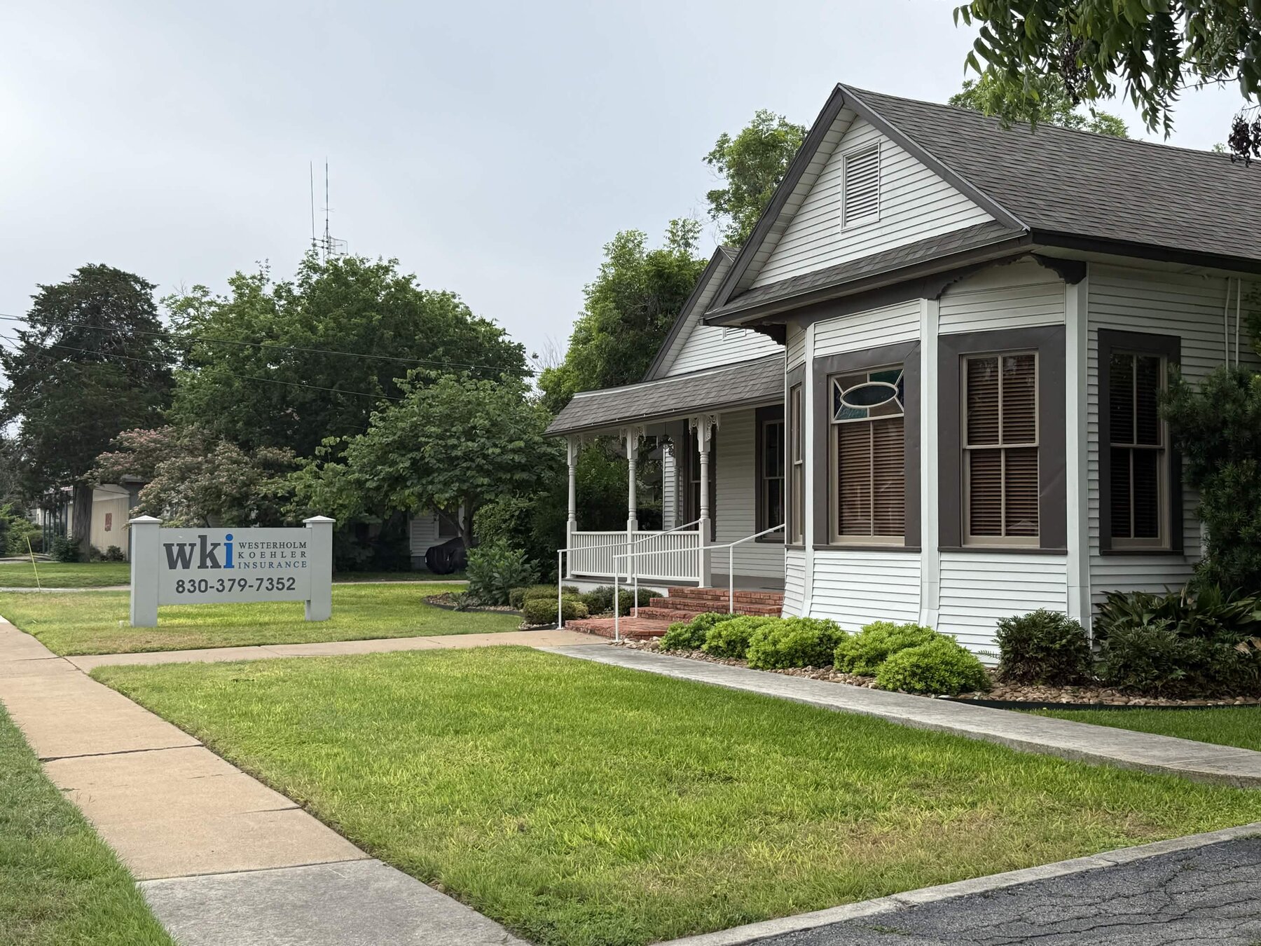 The Westerholm Koehler Insurance office — the historic house at 533 E. Court Street in Seguin, with the WKI sign on the lawn